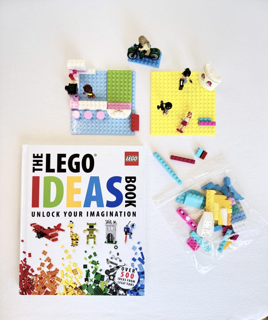 Lego ideas book with loose lego surrounding it